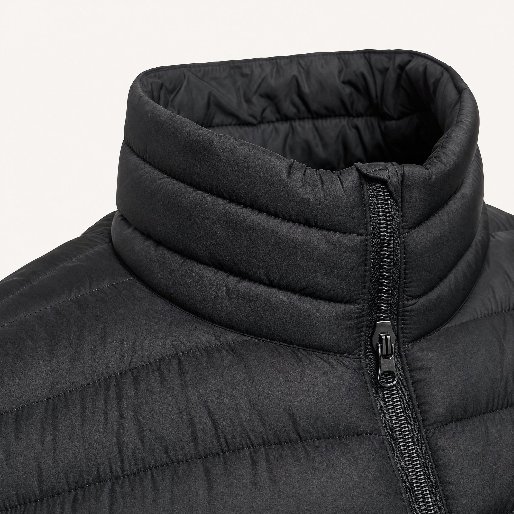 The Treeline Men's Quilted Puffer Jacket in Jet Black, detail close-up