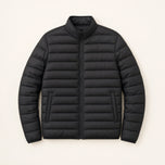 The Treeline Men's Quilted Puffer Jacket in Jet Black, front flat lay