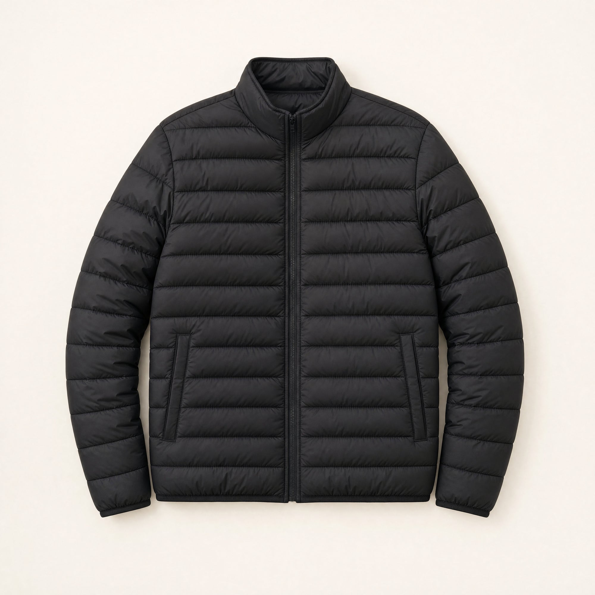The Treeline Men's Quilted Puffer Jacket in Jet Black, front flat lay
