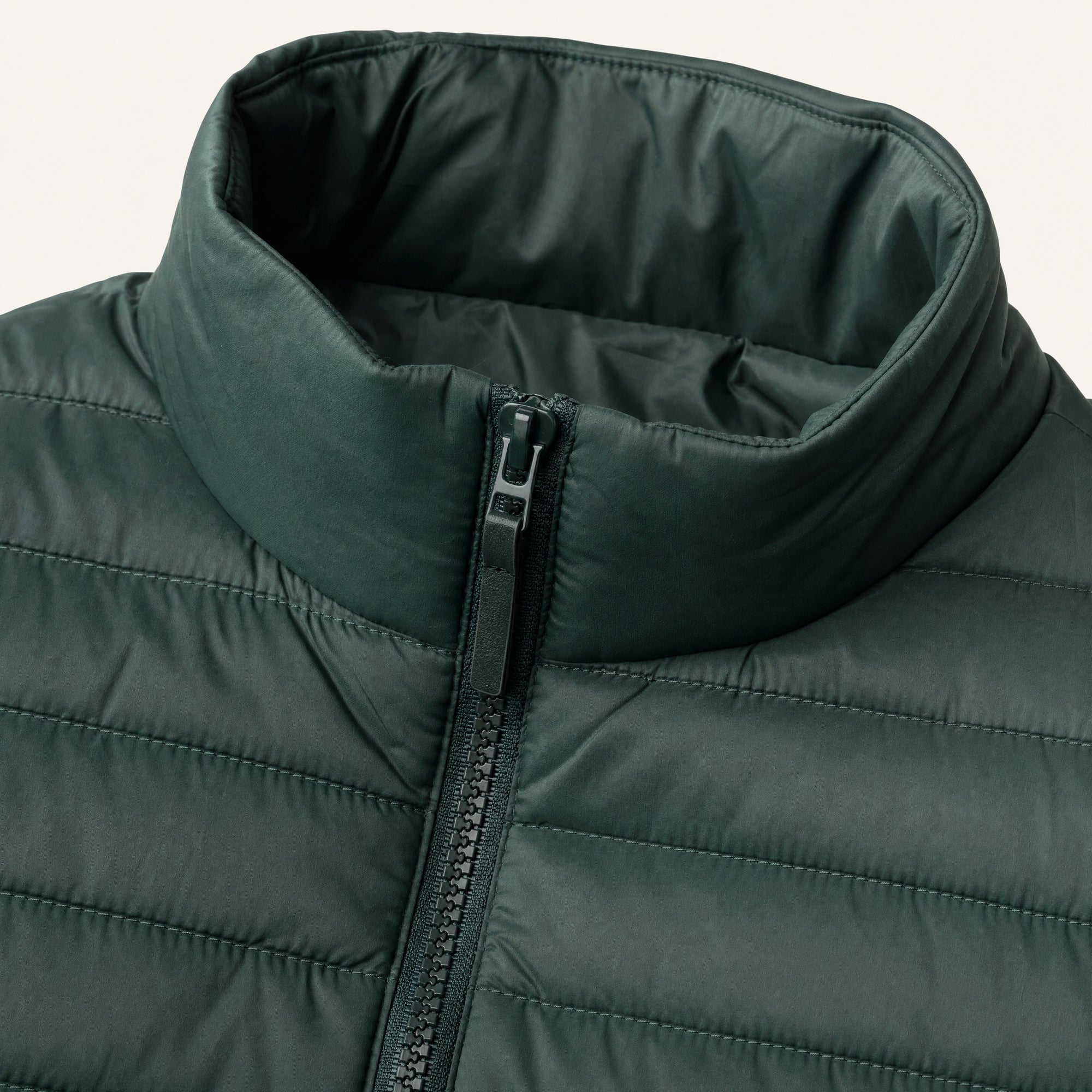 The Treeline Men's Quilted Puffer Jacket in Pine Green, detail close-up
